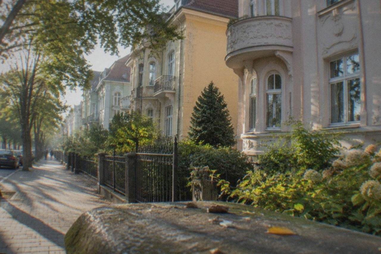 Pastel-colored Secession apartment buildings with ornate facades on a quiet tree-lined street in Elisabetin, Timisoara