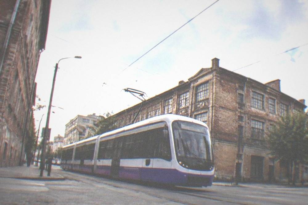 A modern Timisoara tram crossing a junction near the Fabric district