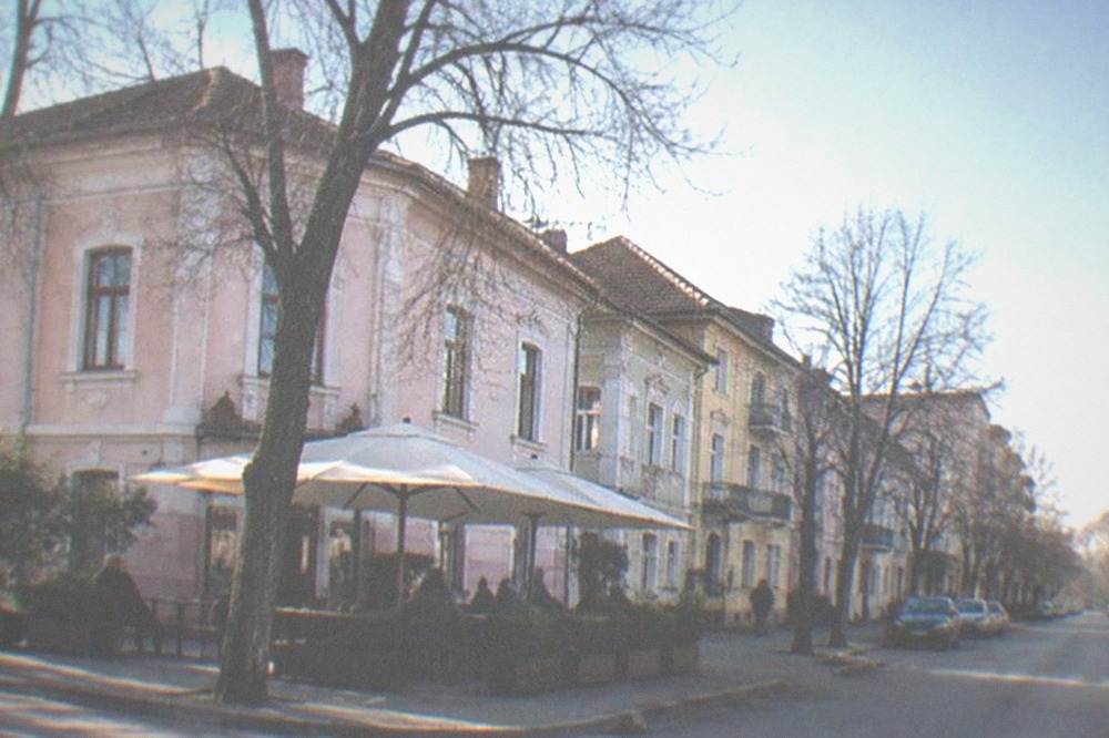 A small neighborhood cafe terrace on a corner street in Iosefin