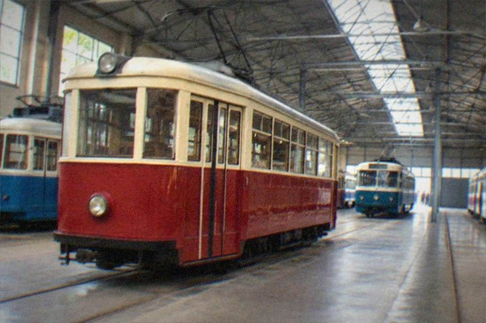 A vintage tram passing colorful facades on a Timisoara boulevard