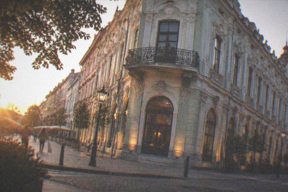 Evening view of a decorated corner building at a street intersection in the old town