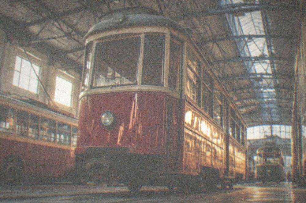 A red vintage tram passing colorful facades in central Timisoara