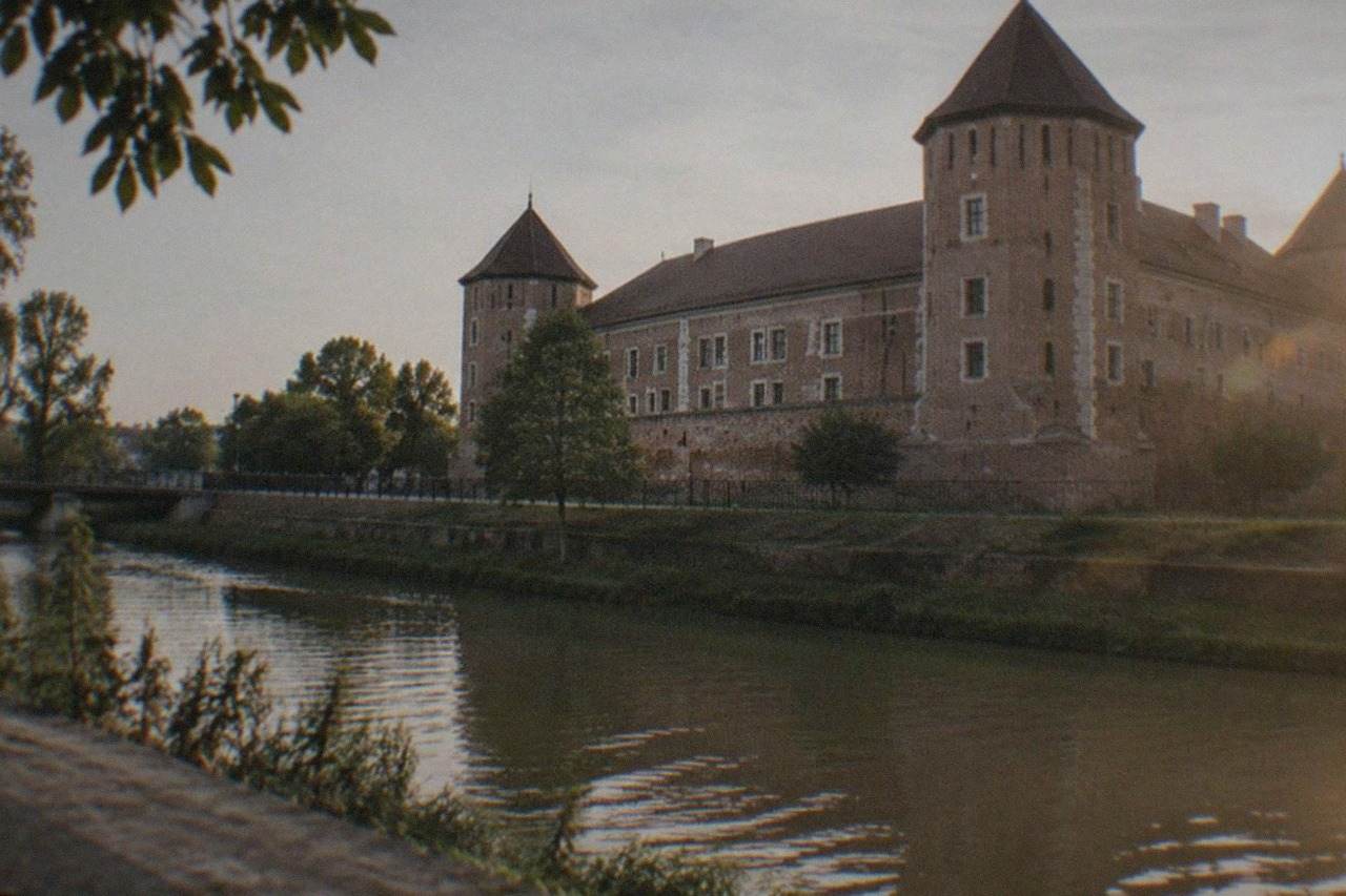 The restored medieval facade of Huniade Castle in Timisoara seen from across the Bega canal