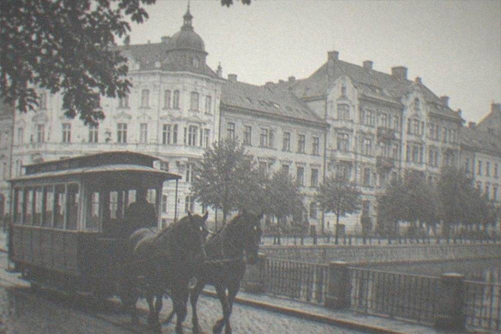 A black and white photograph of a horse drawn tram on a Timisoara street in the nineteenth century