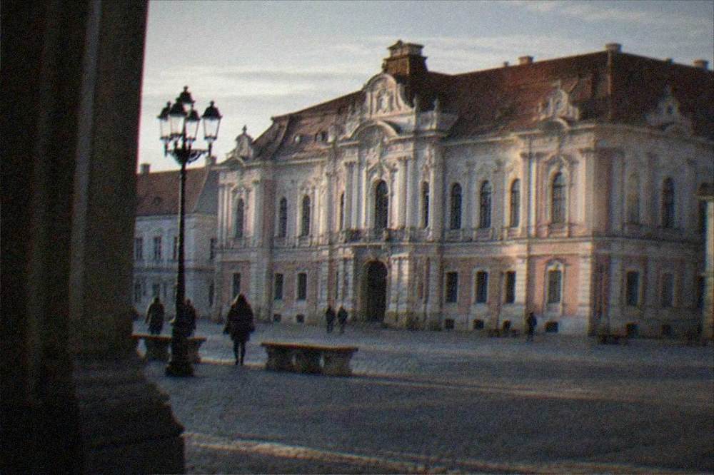 The museum facade lit in late afternoon with the square emptying before evening