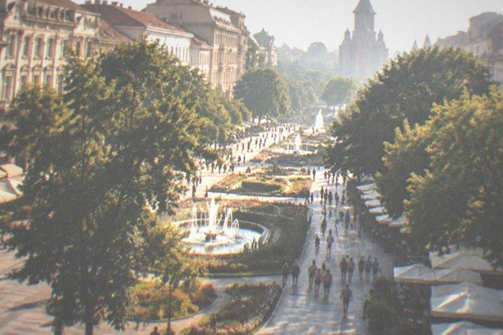 Victory Square in summer with cafe terraces and pedestrians along the boulevard