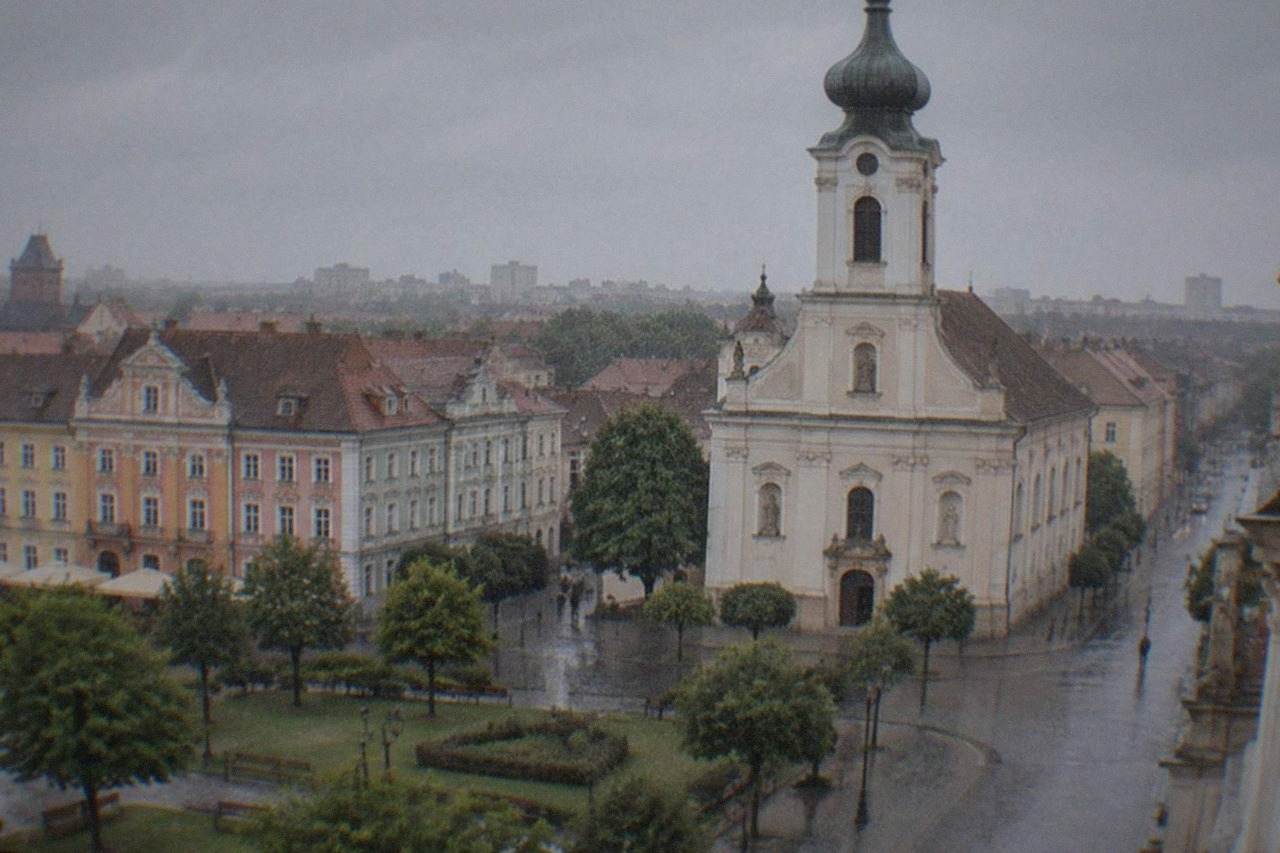 Baroque church towers rising above the colorful facades of a historic city square