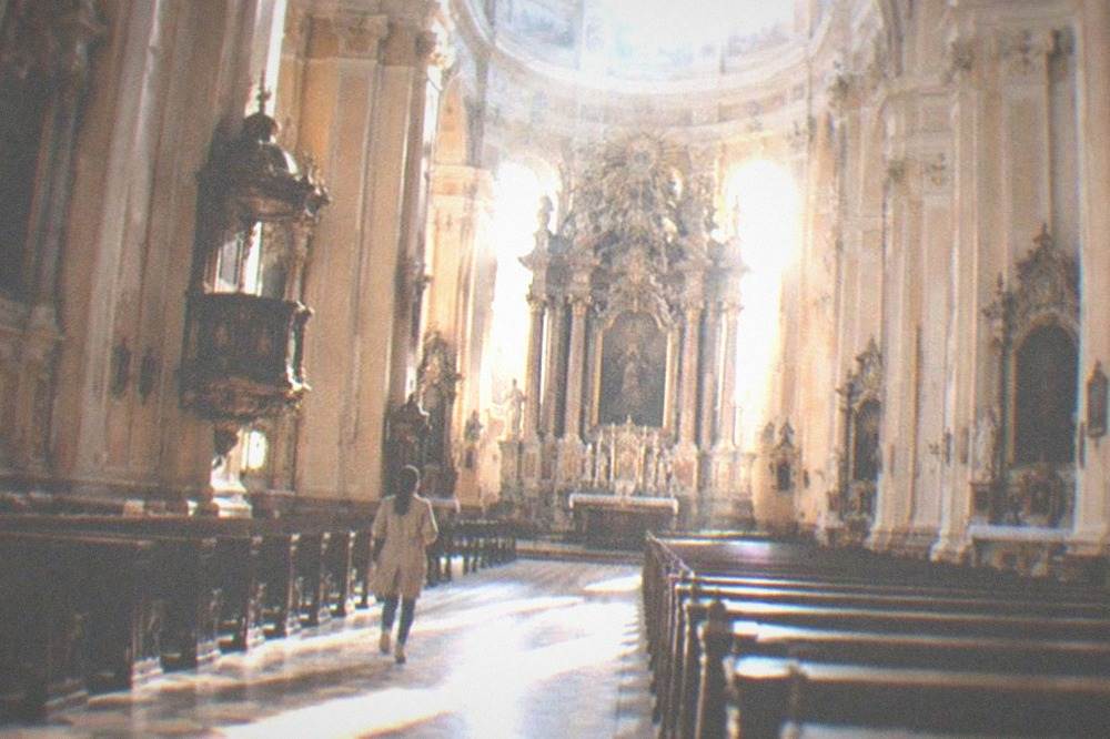 The cathedral interior with columns, side chapels and light falling from the dome