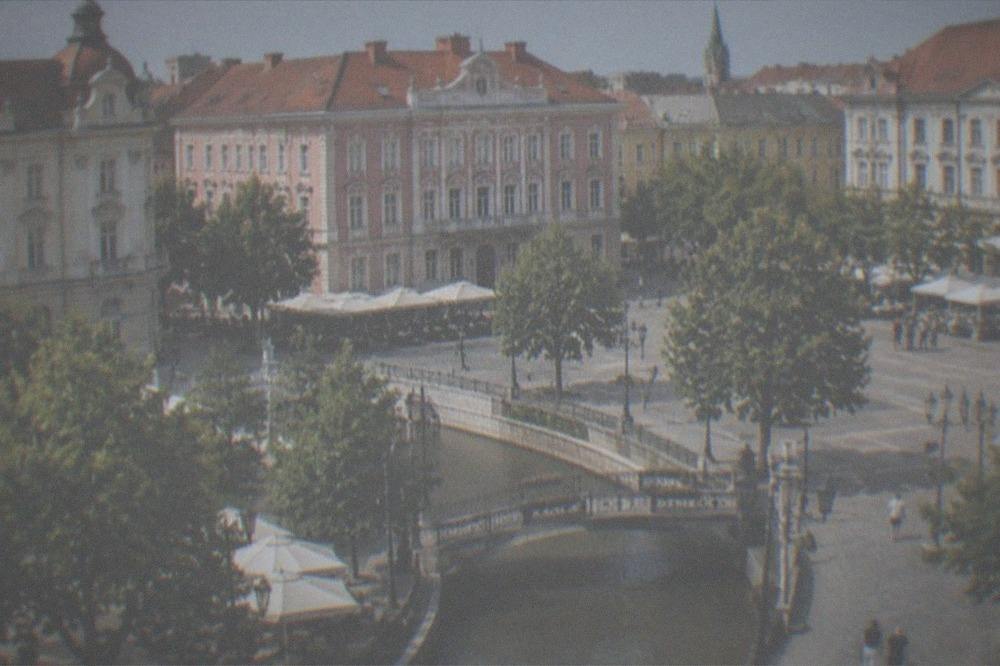 Baroque facades and café tables around a large square in Timisoara
