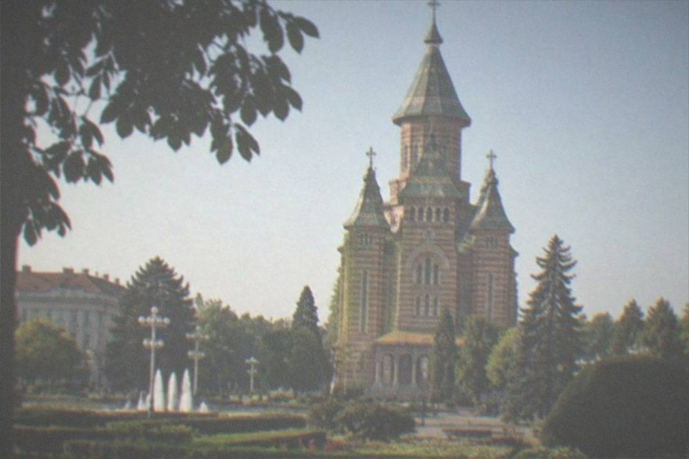 The Orthodox Metropolitan Cathedral towers seen from the green median of Piata Victoriei