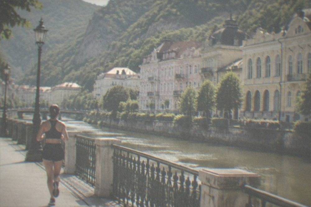 A riverside promenade with ornate historic buildings along the water