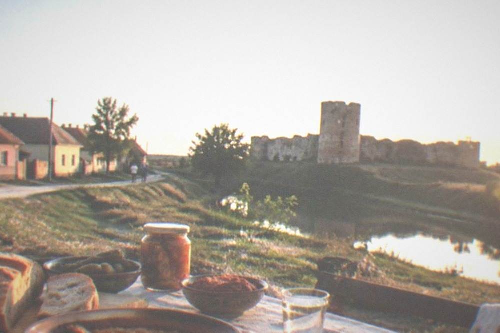 A village lunch table laid with bread, stew and preserves