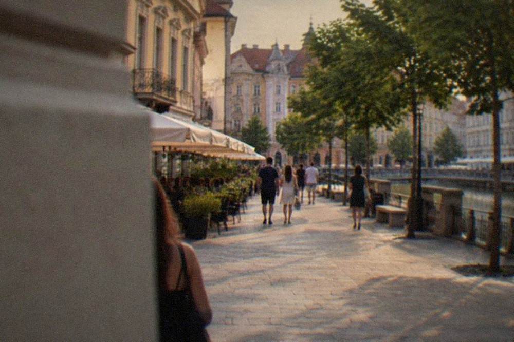 Evening light on a pedestrian street in Timisoara with cafe terraces and people walking