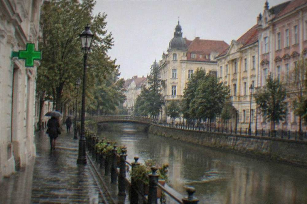 A quiet street corner in Timisoara with a green cross pharmacy sign visible on a building