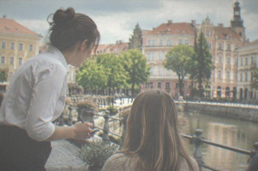 A server taking an order at an outdoor restaurant table in Timisoara