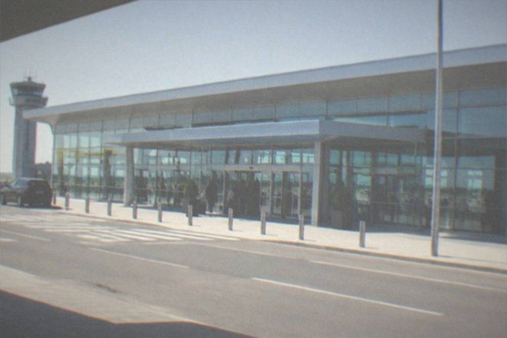Airport terminal exterior with accessible drop-off curb and level entrance