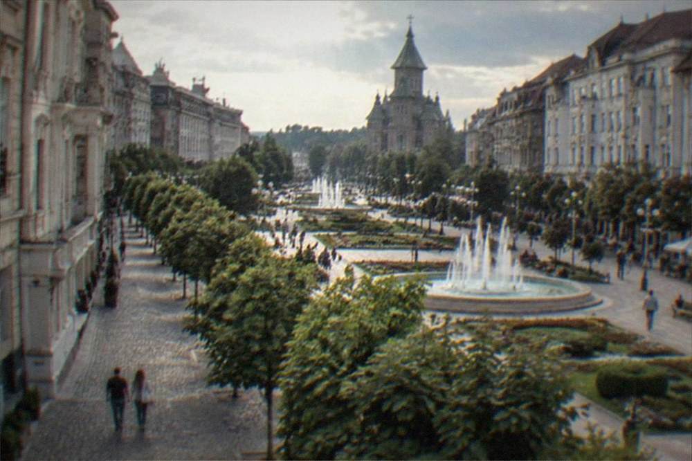 Cobblestone lane in an old European town with a level square visible beyond