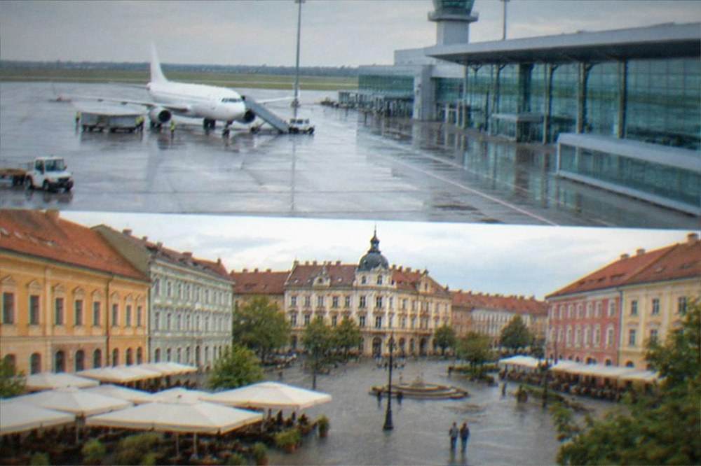 A baroque city square with colorful facades and outdoor cafe tables