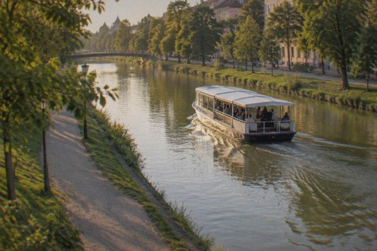 A passenger water bus cruising along the Bega canal in Timisoara on a sunny day