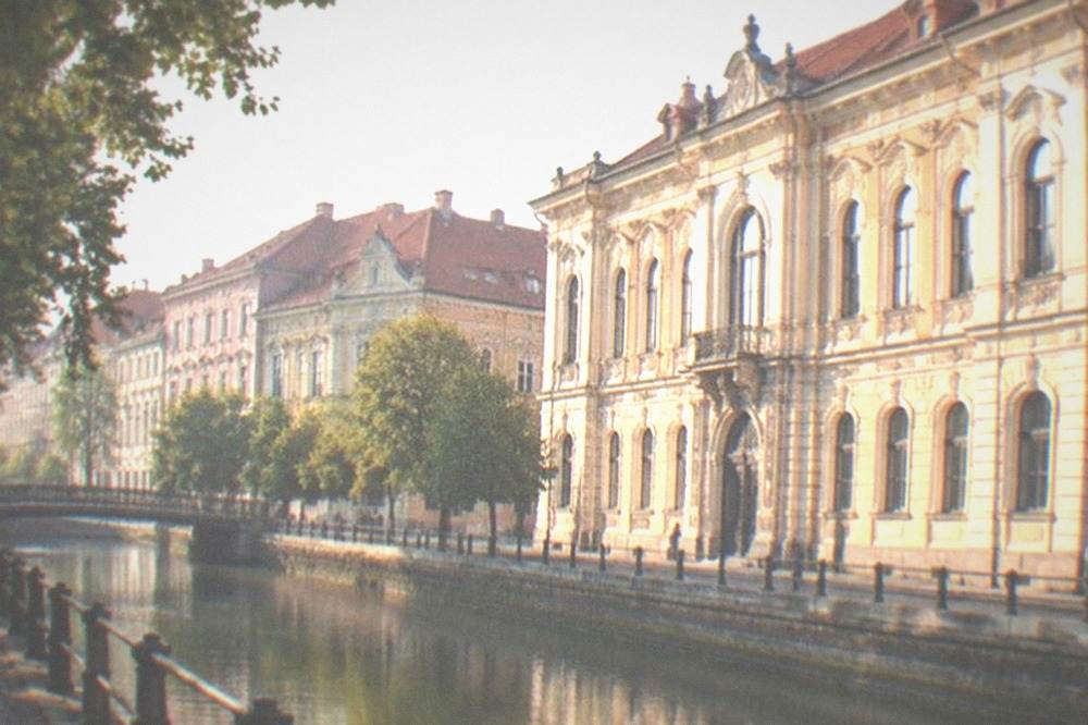 A baroque palace facade with arched windows in Timisoara