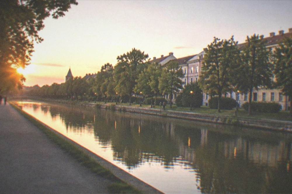 Evening view over the Bega canal with riverside promenade and city lights
