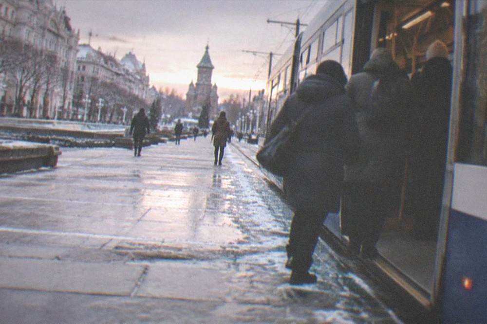 Passengers boarding a tram near Victory Square in Timisoara on a winter evening