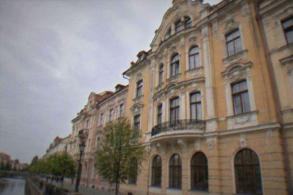 A historic building facade with ornate windows in Timisoara at dusk
