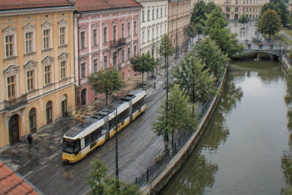 A tram passing colorful facades on a street in central Timisoara