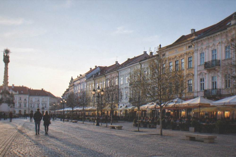 Evening lights and people on a terrace in Union Square in Timisoara