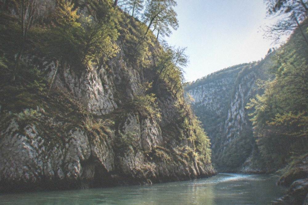 Turquoise river winding through the forested Nera Gorge in the Banat mountains